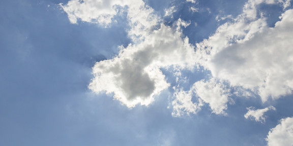 A blue sky with small white clouds.